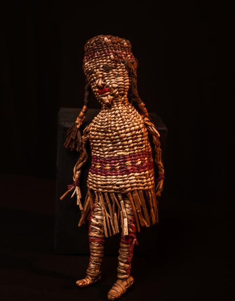 A doll woven from sweetgrass resembling a child