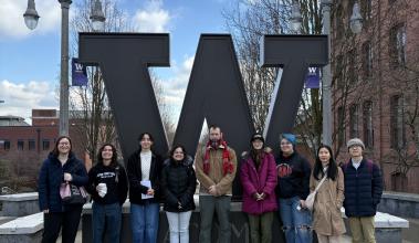 A group of SPSCC students in front of University of Washington Tacoma's W logo statue