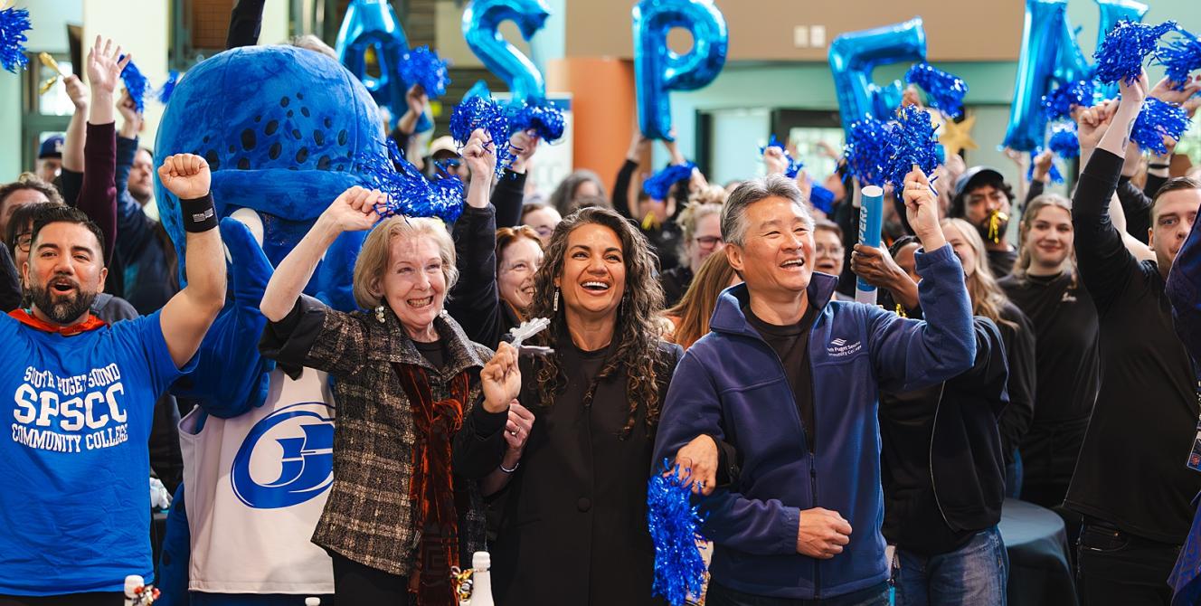 SPSCC staff, faculty, and community members cheering at the Aspen Watch Party