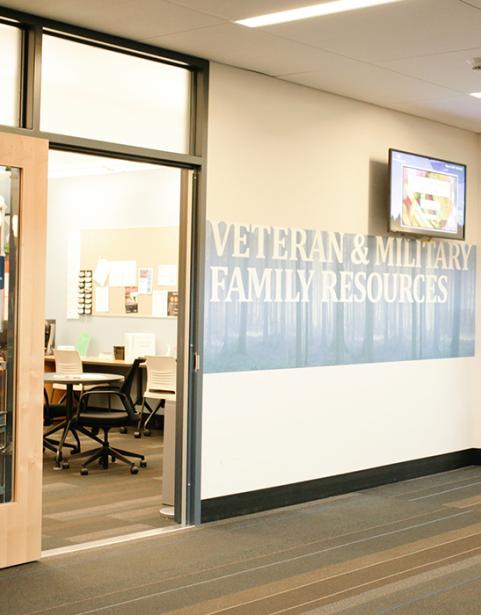 Interior building wall and door with graphic that says "Veteran & Military Family Resources"