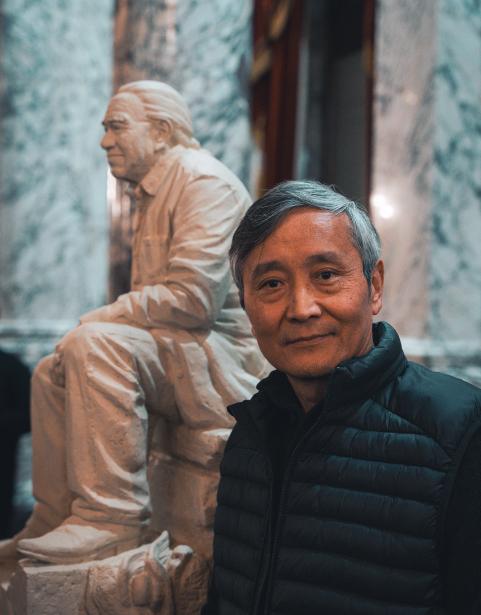 Artist Haiying Wu in front of his model for the Billy Frank Jr. statue