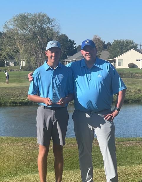 Luke Fenner (left) holds trophy after winning the CBC tournament accompanied by Head Coach Russell Olsen.