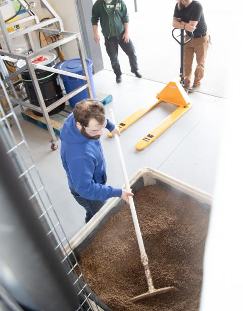A craft brewing and distilling student working on product