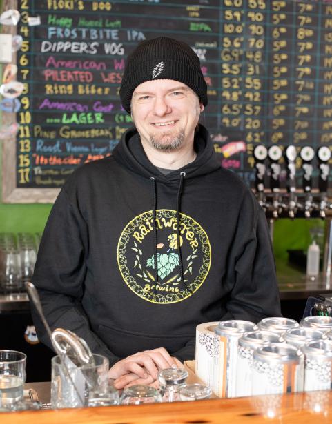 SPSCC alumnus Gavin Rainwater behind the counter at Rainwater Brewery