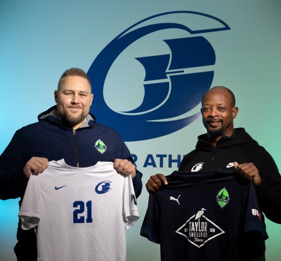 FC Olympia owner Ryan Perkins holding a Clipper jersey alongside SPSCC Director of Athletics Vernell Willingham holding an FC Olympia jersey