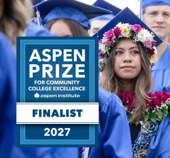 A student wearing a cap and gown decorated with flowers next to a badge that reads "Aspen Prize for Community College Excellence Aspen Institute Finalist 2027"