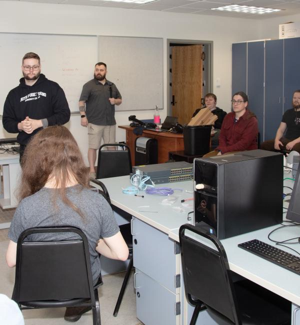 Group of students meet in a computer classroom