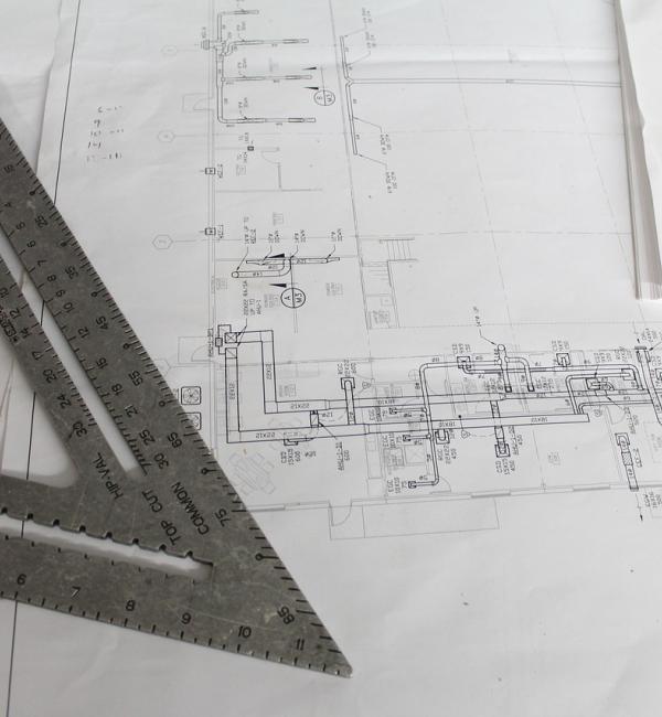 A ruler resting on top of drawn schematics