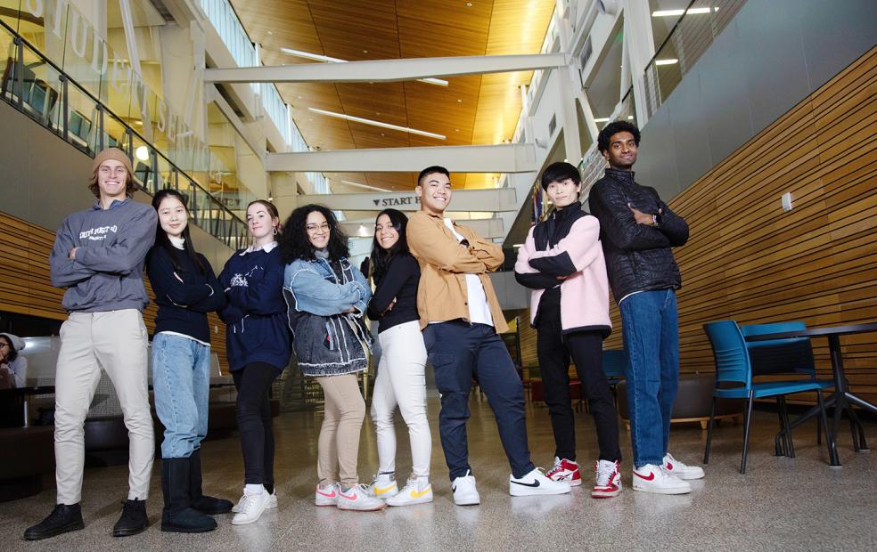 Eight students posing in Building 22