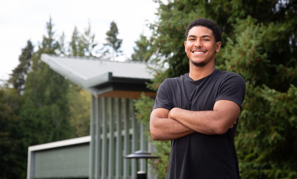 Photo of student-athlete Jason Padilla standing in front of Building 22 with his arms crossed