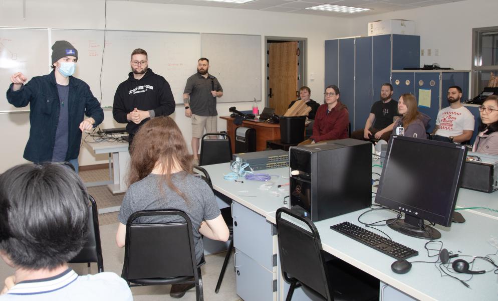 Students sitting in a computer lab listening to a presentation