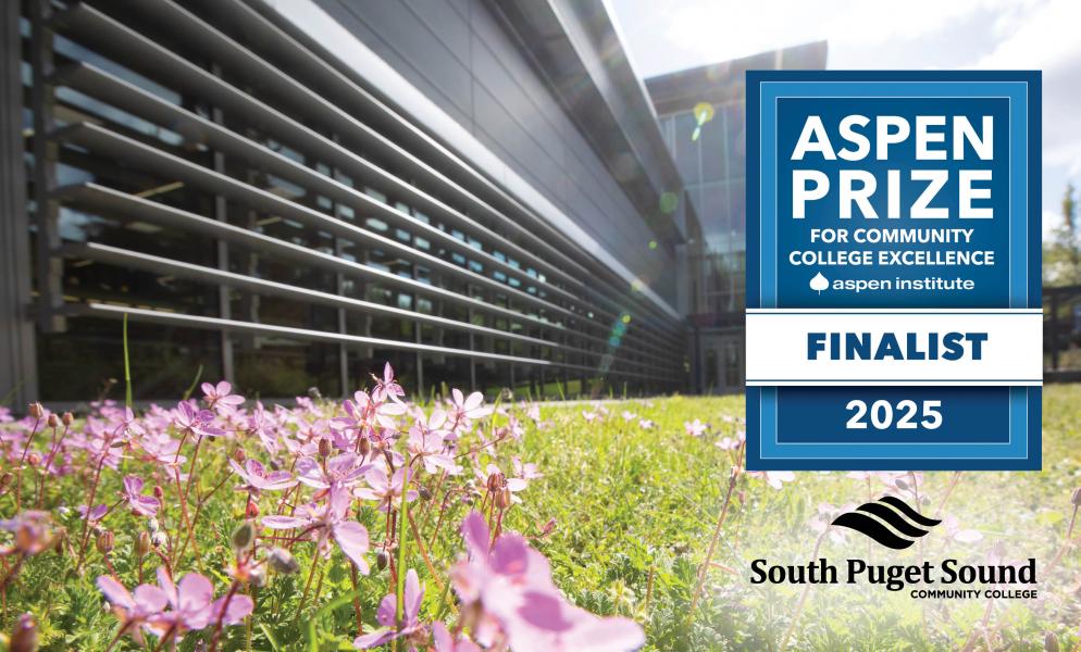 Outside of SPSCC's Building 22 with a badge that reads "Aspen Prize Finalist 2025"