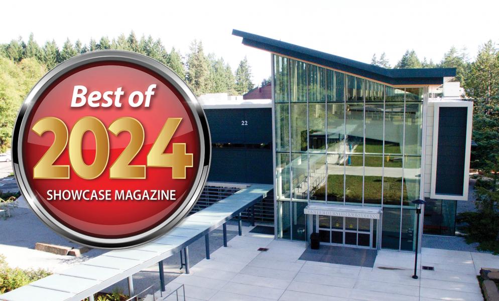 Outside of SPSCC's Bldg. 22 with a badge that reads, "Best of 2024 ShowCase Magazine"
