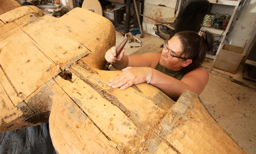 Artist Andrea Wilbur-Sigo (Squaxin Island and Skokomish) working on the SPSCC Welcome Figure in her workshop