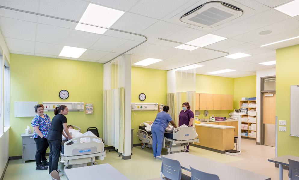 Nursing Students in Nursing Center Attending Patient Beds