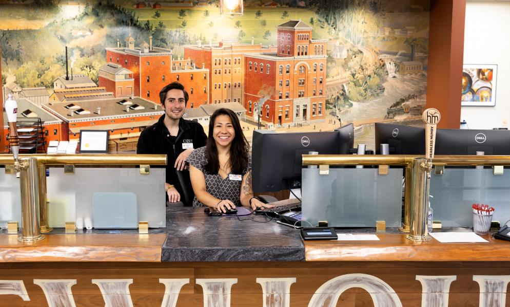 Two O Bee Credit Union staff members behind the desk at a bank