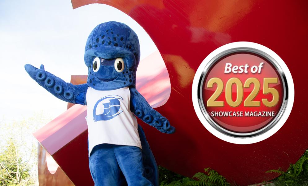 Percy the Kraken standing next to a badge that says "Best of 2025 ShowCase Magazine"