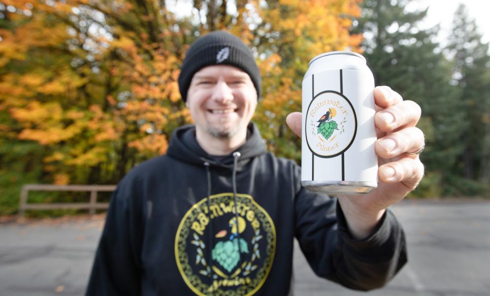 SPSCC alumnus Gavin Rainwater holding a can of his beer